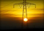 High Voltage Pylons At Sunset Stock Photo