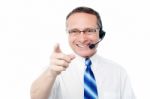 Mature Business Execuitve With Headset Stock Photo