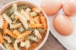 Fusili Pasta In Wooden Plate With Eggs Stock Photo