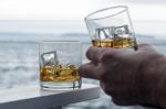 Whiskey On The Rocks By The Sea Stock Photo