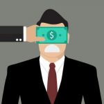 Businessman With Dollar Banknote Taped To Eyes Stock Photo
