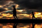Father And Son Playing With Silhouettes Stock Photo