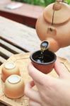 Pouring Chinese Tea On The Cup Stock Photo