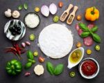 The Ingredients For Homemade Pizza On Dark Stone Background Stock Photo