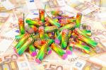 Heap Of Colorful Fire Work On Spread Euro Notes Stock Photo