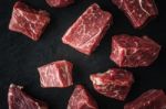 Raw Angus Beef Slices On The Black Stone  Table Stock Photo