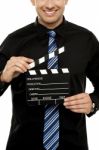 Cropped Image Of Man With Clapboard Stock Photo