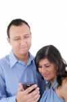 Couple Looking At A Cell Phone And Smiling Isolated On A White B Stock Photo
