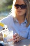 Beautiful Young Woman Drinking Soda In A Restaurant Terrace Stock Photo