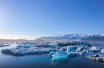 Wide Landscape Of Icebergs Floating On The Water Under The Very Clear Blue Sky With Copy Space Stock Photo