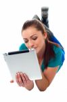 Relaxed Young Woman Surfing On Tablet Device Stock Photo