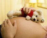 Pregnant Mother Holding Teddy Bear Stock Photo
