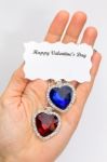 Hand Showing Red And Blue Jewelry Hearts For Valentine Stock Photo
