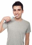Young Man Brushing Teeth Stock Photo