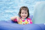 Baby Girl Floating In Swimming Pool Stock Photo