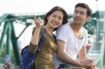 Couples Of Younger Asian Man And Woman Relaxing With Happy Face On Vacation Tirp Stock Photo