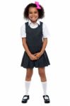 Cheerful Young Kid In Pinafore Dress Posing Smilingly Stock Photo