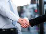 Close-up Of Business People Handshaking Stock Photo