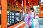 Women In Traditional Japanese Kimonos At Fushimi Inari Shrine In Kyoto, Japan Stock Photo