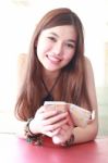 Portrait Of Thai Adult Beautiful Girl Using Her Smart Phone And Smile Stock Photo
