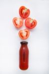 Tomatoes Juice In Bottle And Fresh Tomatoes Slices On White Wood Stock Photo