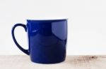Blue Cup On Wooden Stock Photo