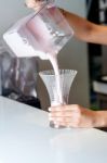 Chef Filling Glass With Milkshake Stock Photo