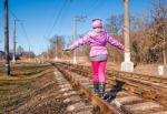 Little Girl Is Walking On Rails Stock Photo