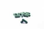 Green Capsule Pills On White Background Stock Photo