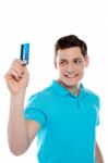 Handsome Young Man Holding Credit Card Stock Photo