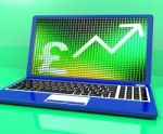 Pound Sign And Up Arrow On Laptop For Earnings Or Profit Stock Photo