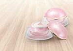 Pink Dome Cosmetic Jar On Wood Background Stock Photo