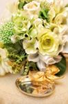 Bridal Bouquet And Wedding Rings On The Table Stock Photo