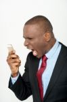 Angry Business Man Screaming On Cell Phone Stock Photo