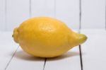 Yellow Lemon Over White Wood Background Stock Photo