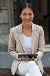 Young Woman With Tablet Out In The City Stock Photo