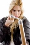 Front View Of Aggressive Female Holding Nunchaku Stock Photo