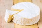Camembert Cheese With Cut Wedge And Vintage Knife On Wooden Tabl Stock Photo