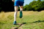 Young Fit Man Running Outdoors Stock Photo