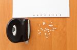 Hole Puncher With Paper And Confetti On The Office Table Stock Photo