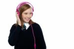 Pretty Schoolgirl Enjoying Music Stock Photo