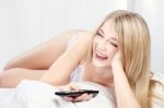 Smiling Woman On Bed Stock Photo
