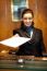 Female Receptionist Giving Paper