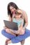 Young Mother And Daughter Looking At Laptop.  Focus In The Mothe