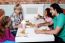 Cheerful Family Of Four Enjoying Breakfast