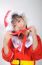 Asian Little Girl Dressed In Santa Claus Holding Red Ribbon