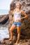 Beautiful Young Blonde Woman Posing Outdoor At The Rocky Sea Sho