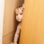 Curious Cute Baby Boy Looking Through Ajar Door