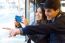 Young Couple Taking Selfies With Smartphone At Bus