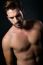 Handsome Muscular Male Model Posing Over Black Background